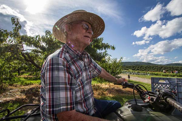 Charles Weed Charlie Weed sits on his 4 wheeler admiring the farm.