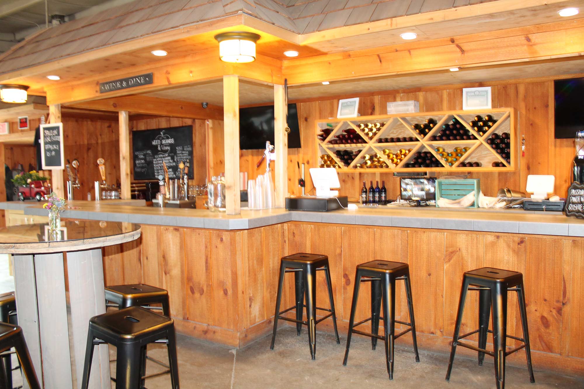 A side view of the winery that shows bar stool seating near the winery counter.
