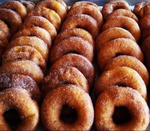 A close up of an entire tray of apple cider donuts