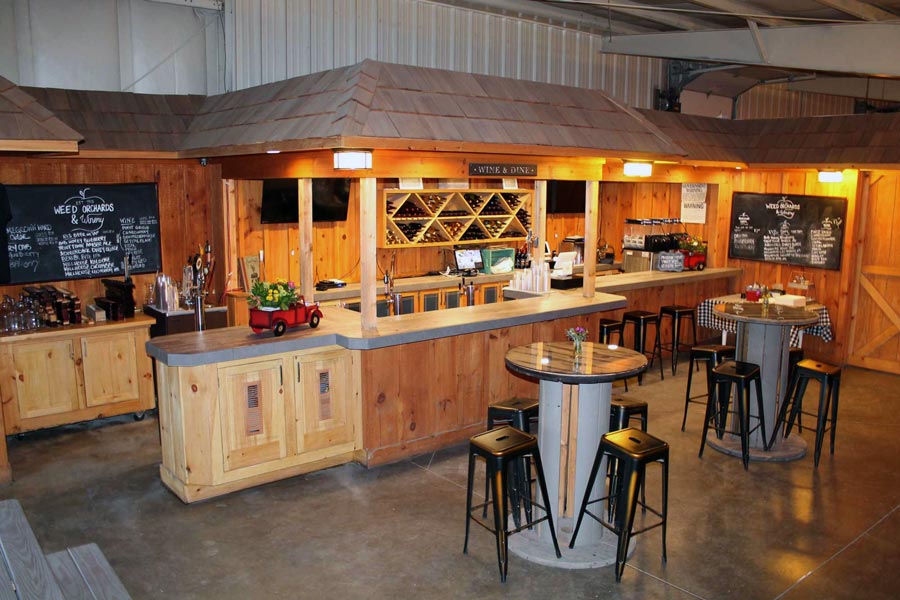 A tasting Room with woodwork and metal barstool benches