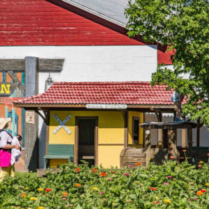 A yellow playhouse resembling a railroad station.