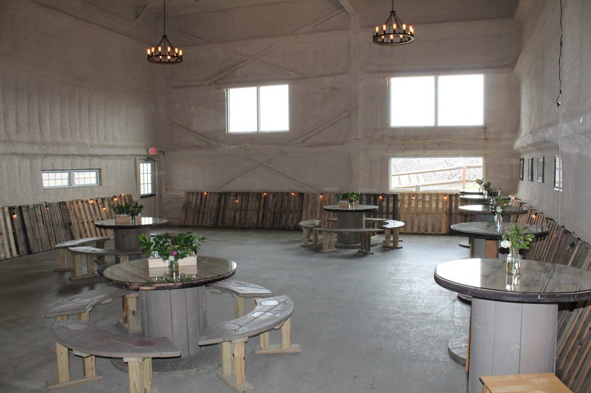 The Private Party room with circular round tables, concrete floor and high ceilings.