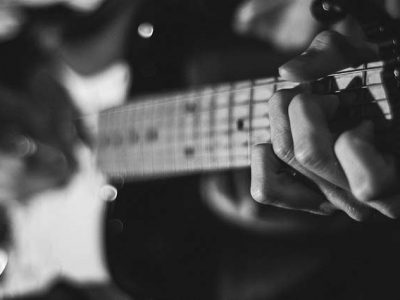 Close up of hands playing guitar