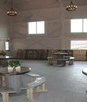A small thumbnail of a while walled venue with wooden tables